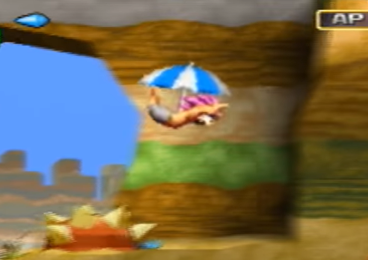 Skærmbillede fra spillet Tombi, hvor spilleren bruger en parasol til at falde langsommere